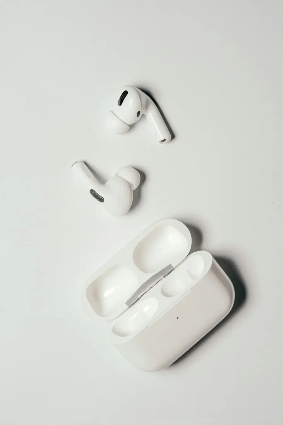 White wireless earbuds and their charging case